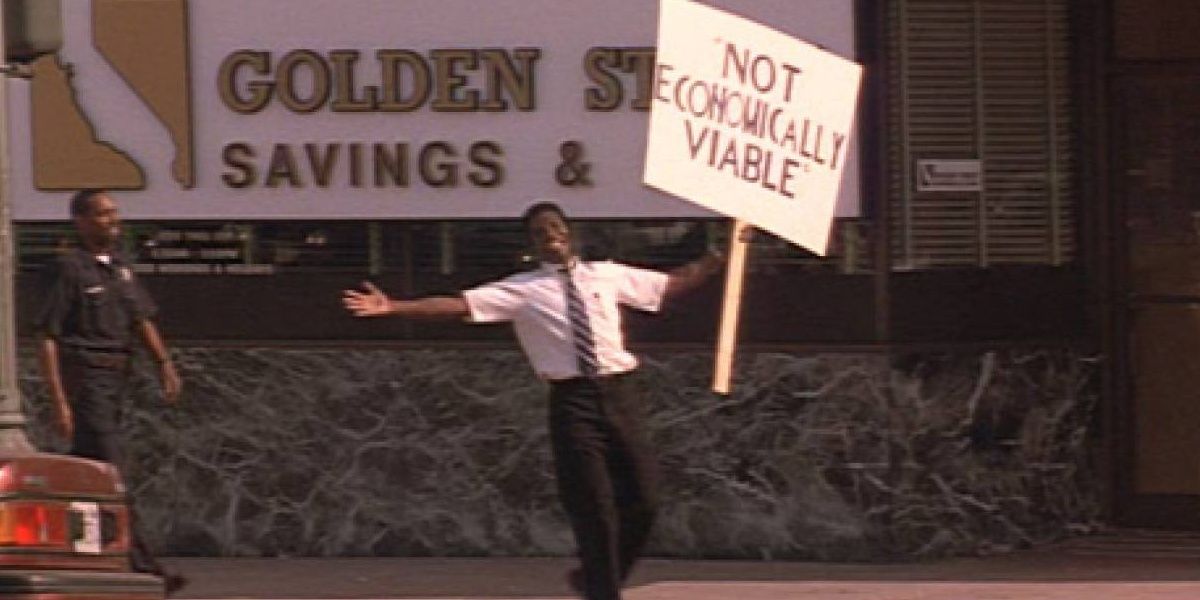 Vondie Curtis-Hall standing outside bank with sign in Falling Down