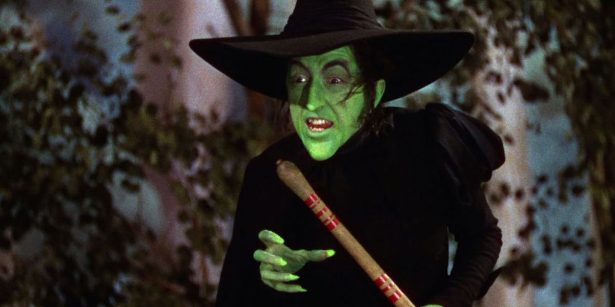 The Wicked Witch of the West holding broomstick in the Wizard of Oz