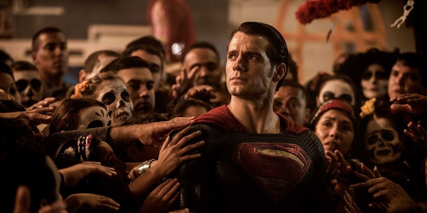 A group of people touching Superman in Batman v Superman