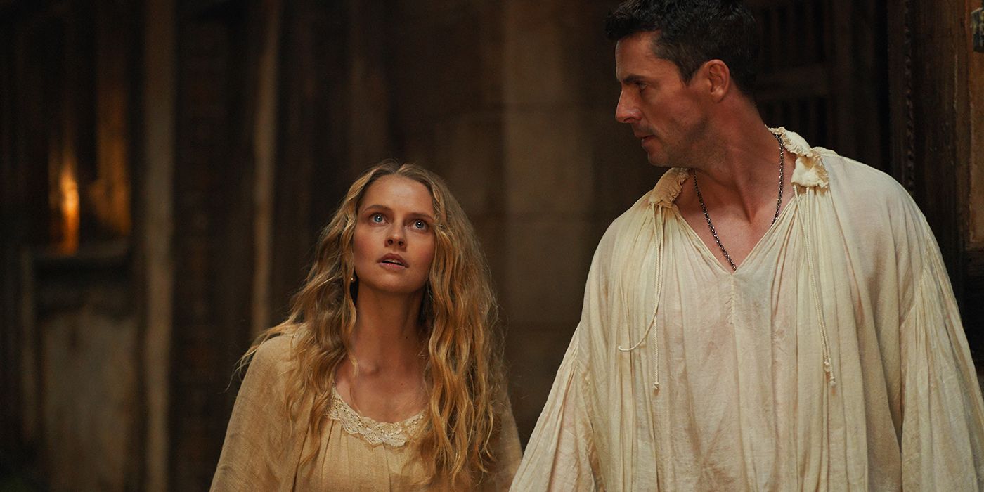 Matthew (Matthew Goode) and Diana (Teresa Palmer) in a dark hall in A Discovery of Witches in A Discovery of Witches