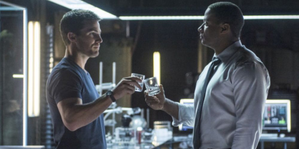 Oliver and Diggle talking in their lair in Arrow