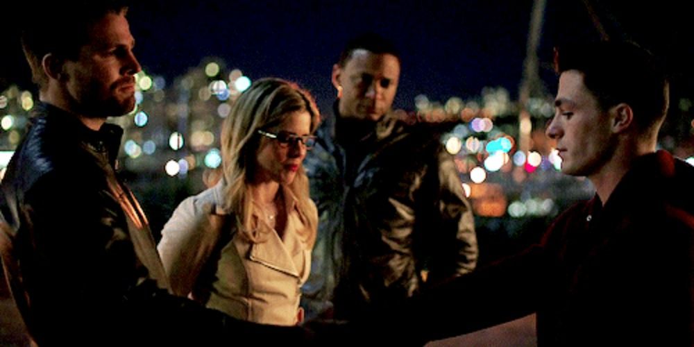 Oliver Queen, Felicity Smoak and John Diggle look at Roy Harper in Arrow