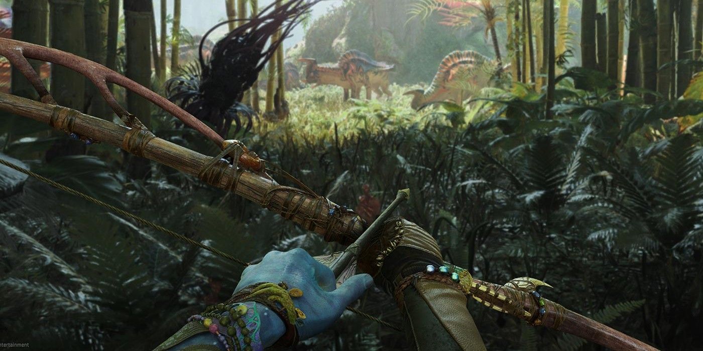 A first-person screenshot from an Avatar: Frontiers of Pandora trailer, showing the Na'vi main character drawing a bow while hiding in foliage near wildlife.