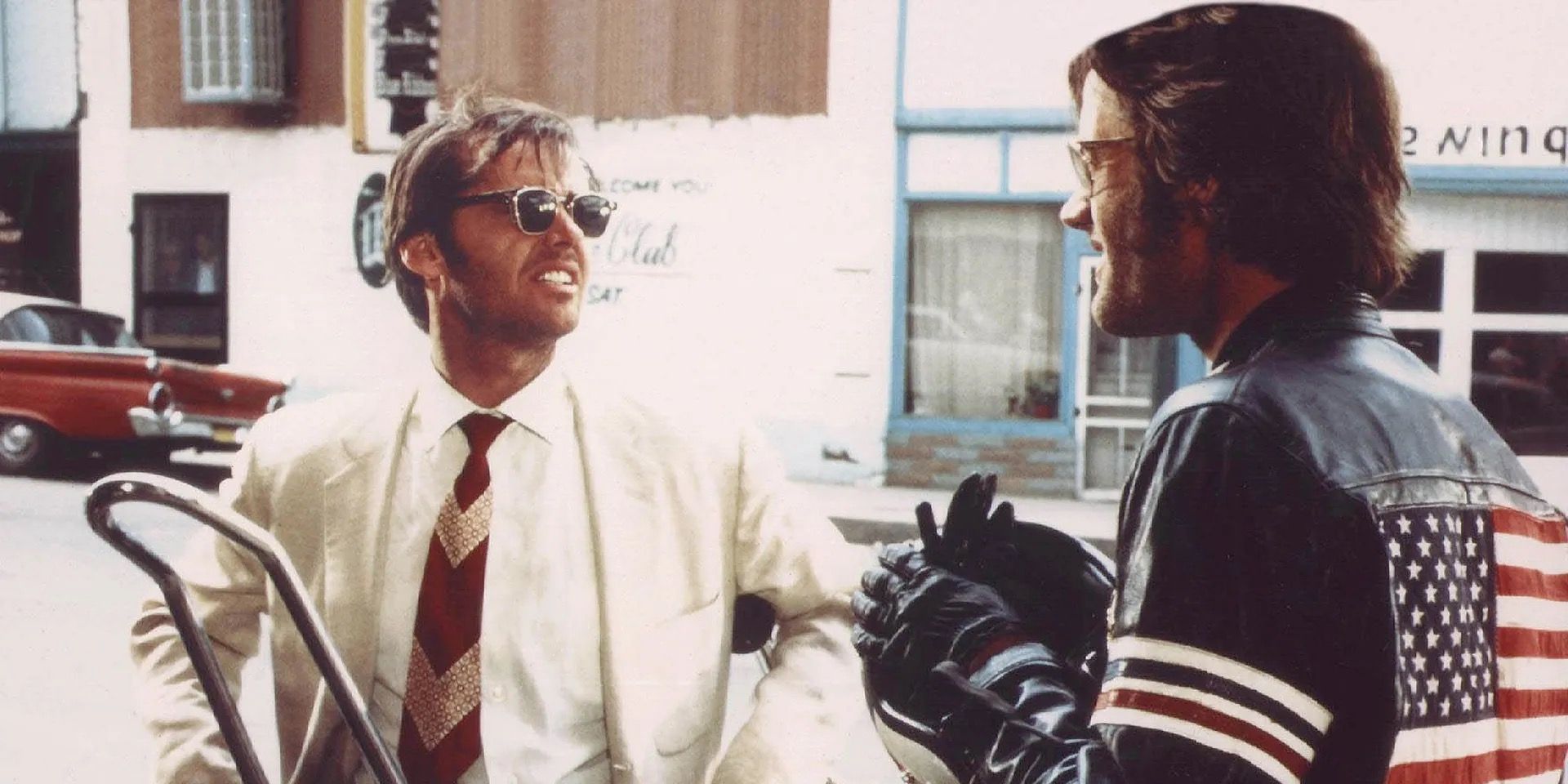 Jack Nicholson talking wearing a white shirt and sunglasses in Easy Rider