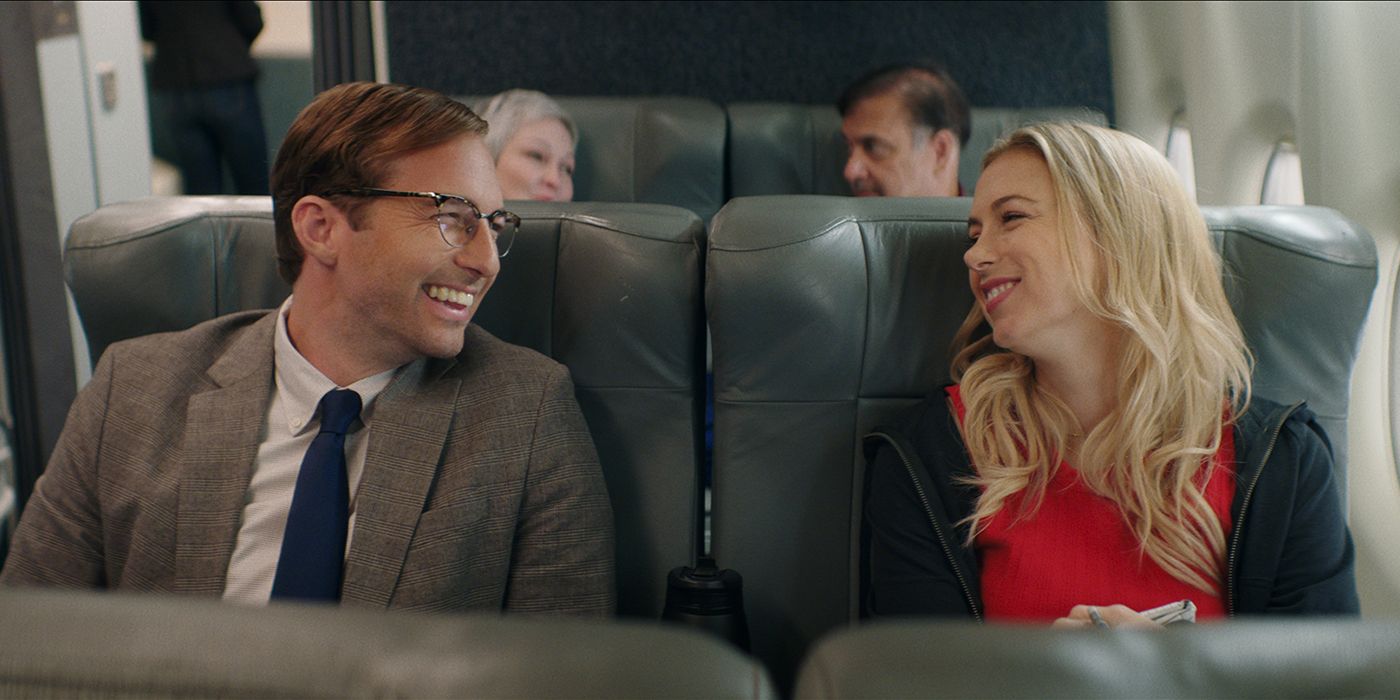 Ryan Hansen and Iliza Shlesinger smiling on a plane in Good On Paper