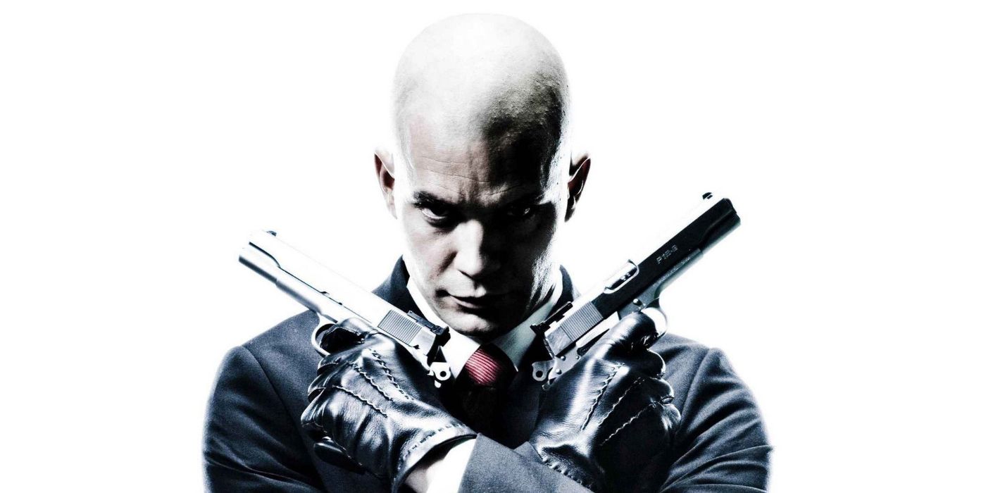 The Hitman poses with two pistols from the film Hitman