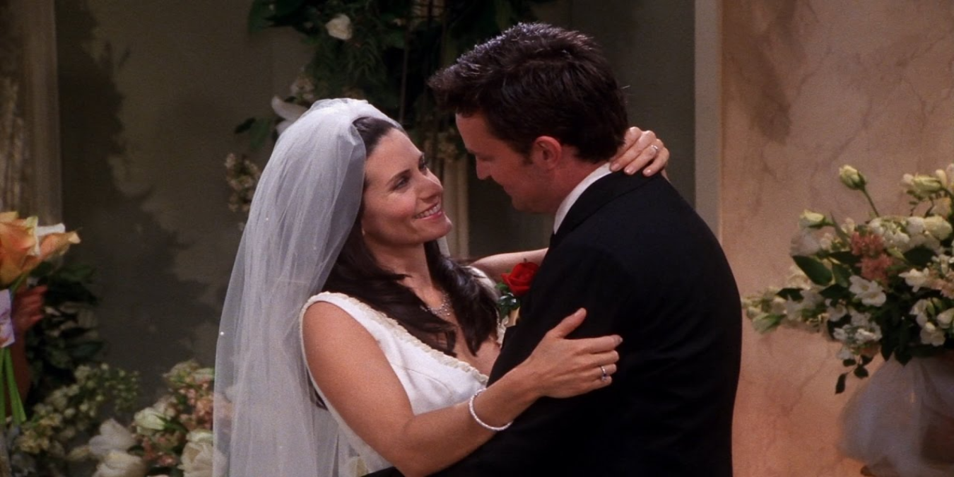 Monica and Chandler smiling at each other while getting married in Friends