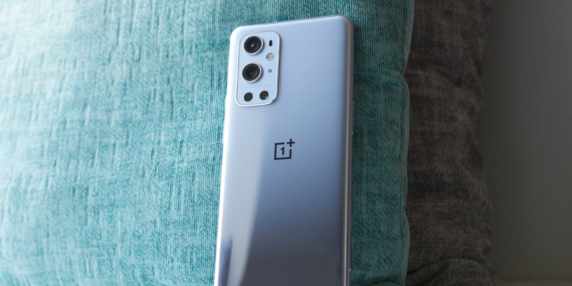 OnePlus 9 Pro standing up against a pillow