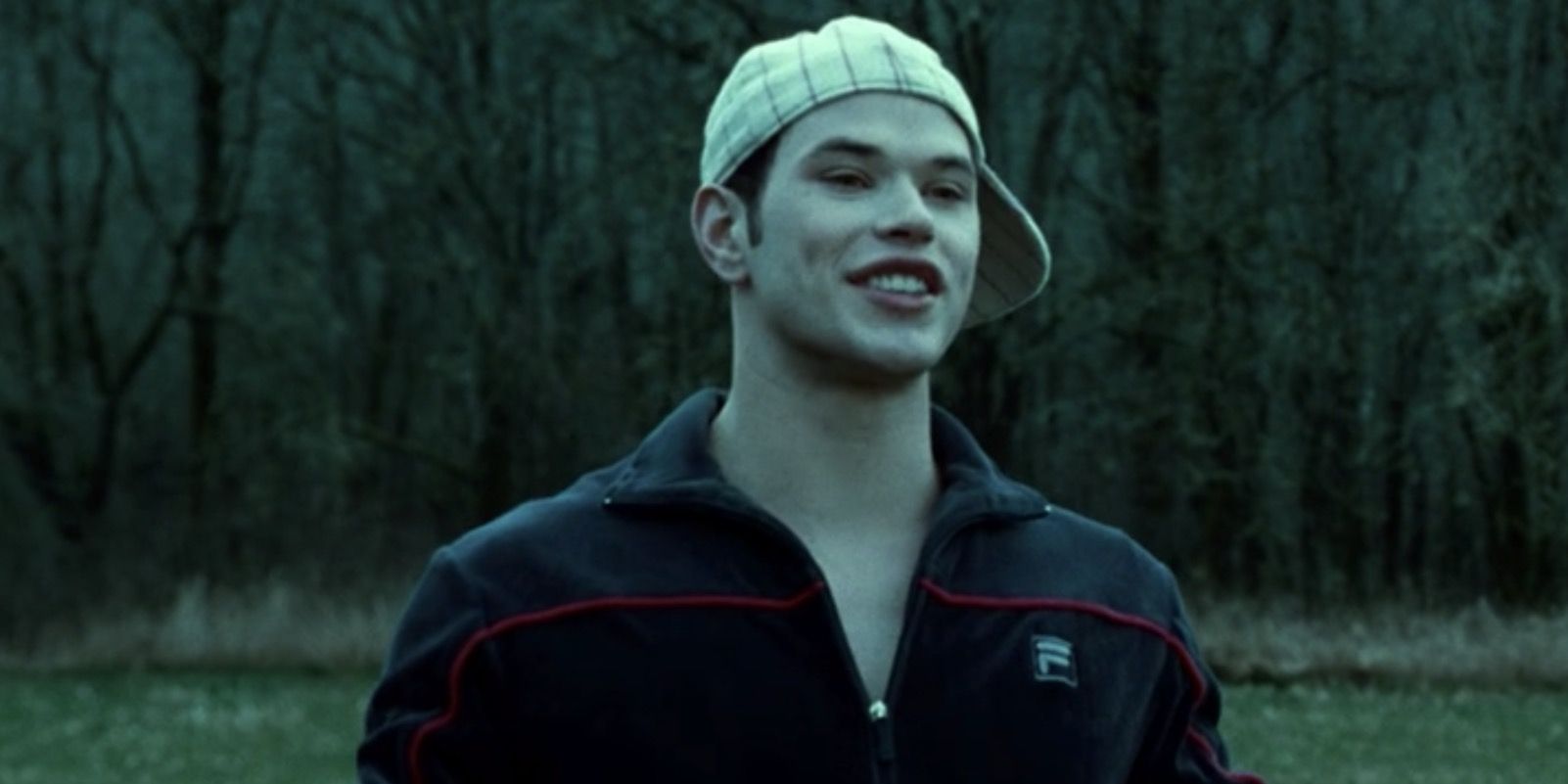 Emmett standing on baseball field wearing white baseball cap in Twilight