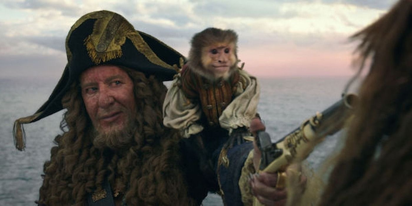 Barbossa pointing a sword with a monkey on his shoulder in Pirates of the Caribbean 5