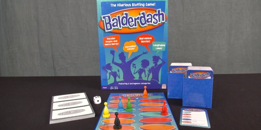 Cards, game pieces, and box on a table for Balderdash game