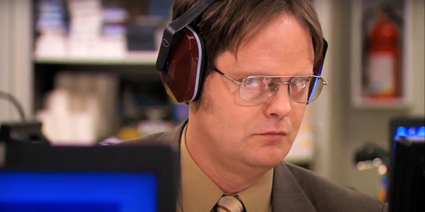 Dwight Schrute wearing headphones, looking sly