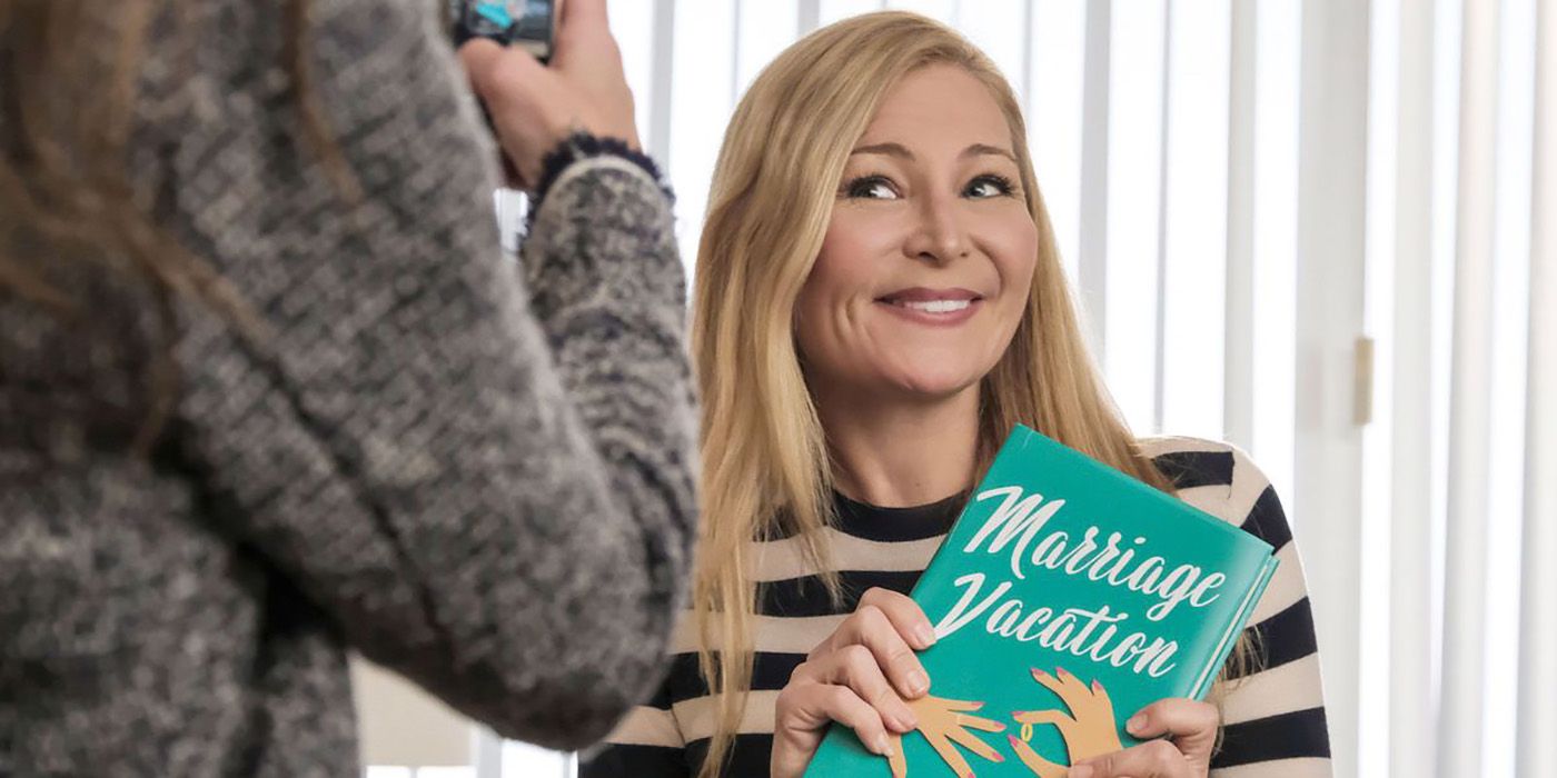 Charles' ex-wife Pauline holding up her book Marriage Vacation on Younger