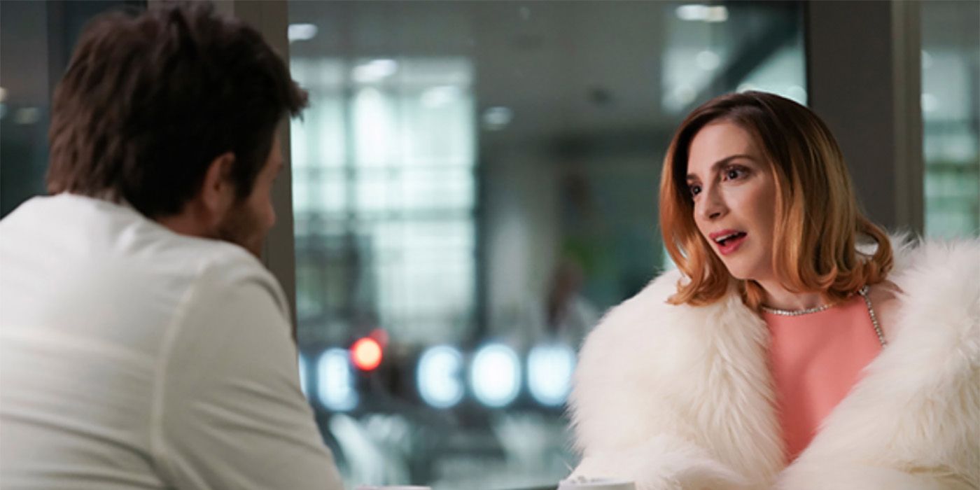 Lauren wearing a big white fur coat talking to Max on Younger