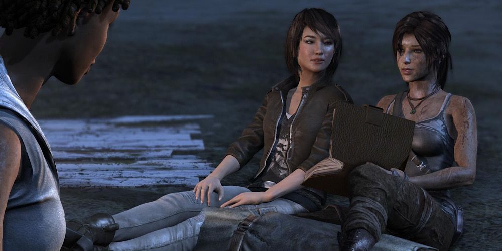 Lara and Sam sit on the ground in Tomb Raider