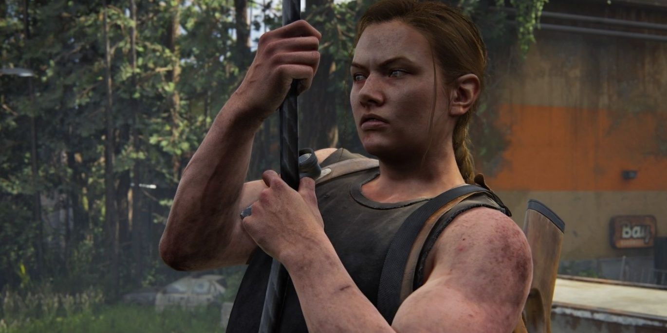 Abby holds on to a rope and looks angry in The Last of Us