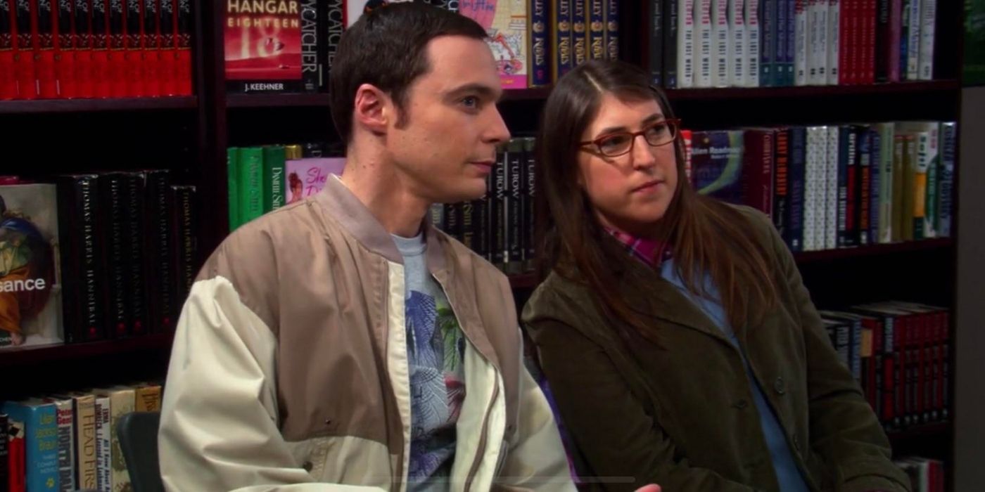 Amy and Sheldon sitting at a book lecture on TBBT