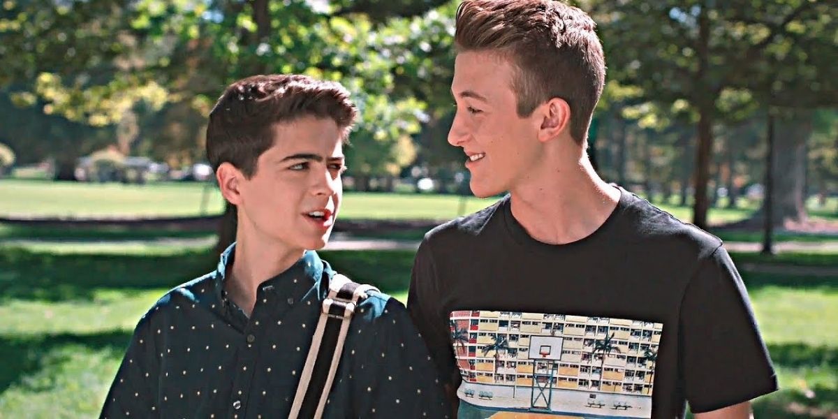 Cryus and TJ walking through a park in Andi Mack.