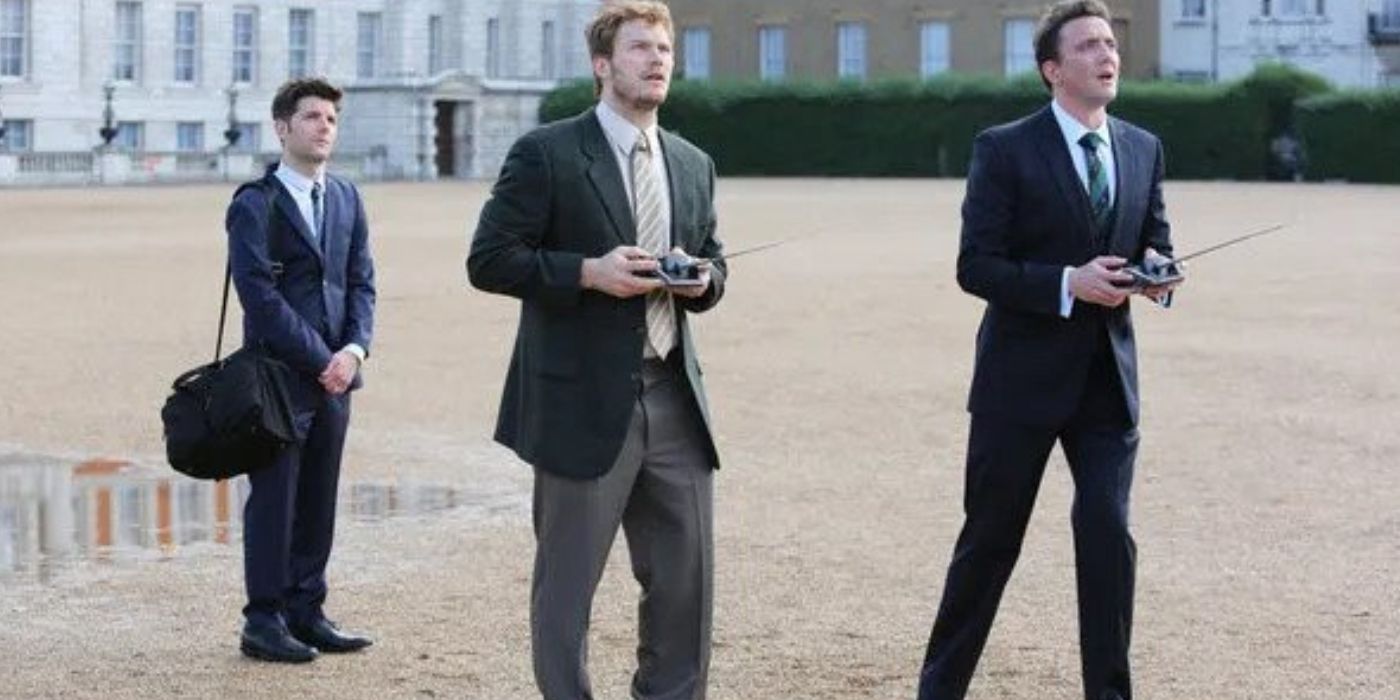Andy Dwyer holding a remote control while Ben Wyatt in a still from Parks and Recreation