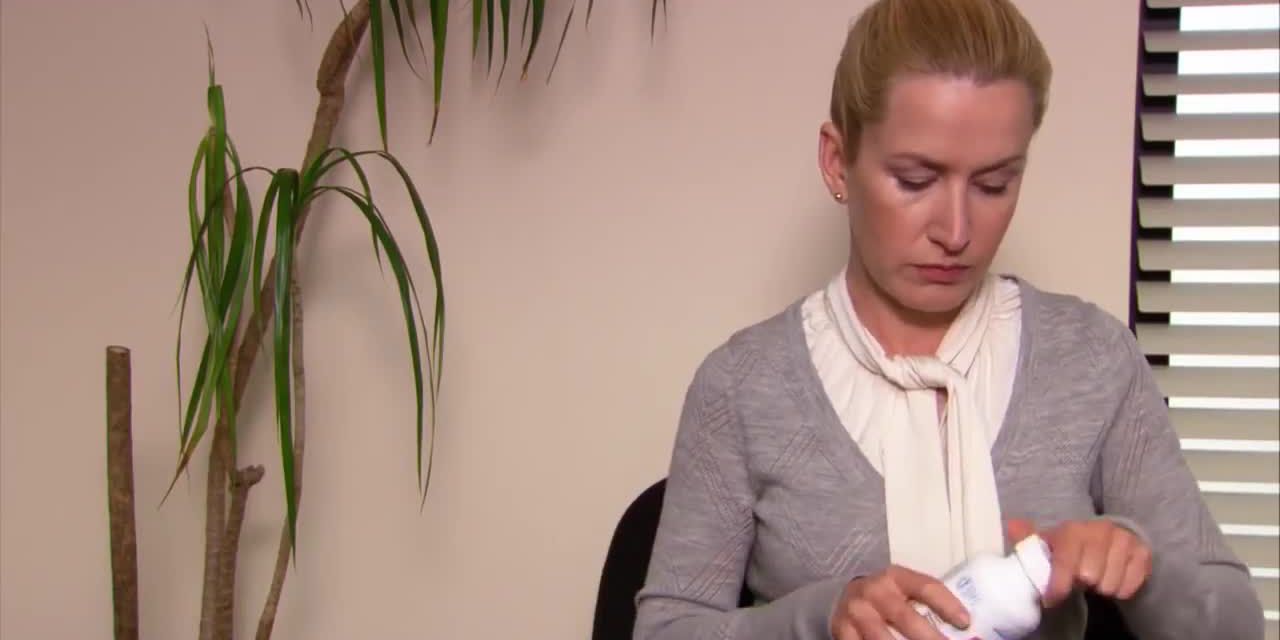Angela Martin prepares for a headache with pain killers in The Office.