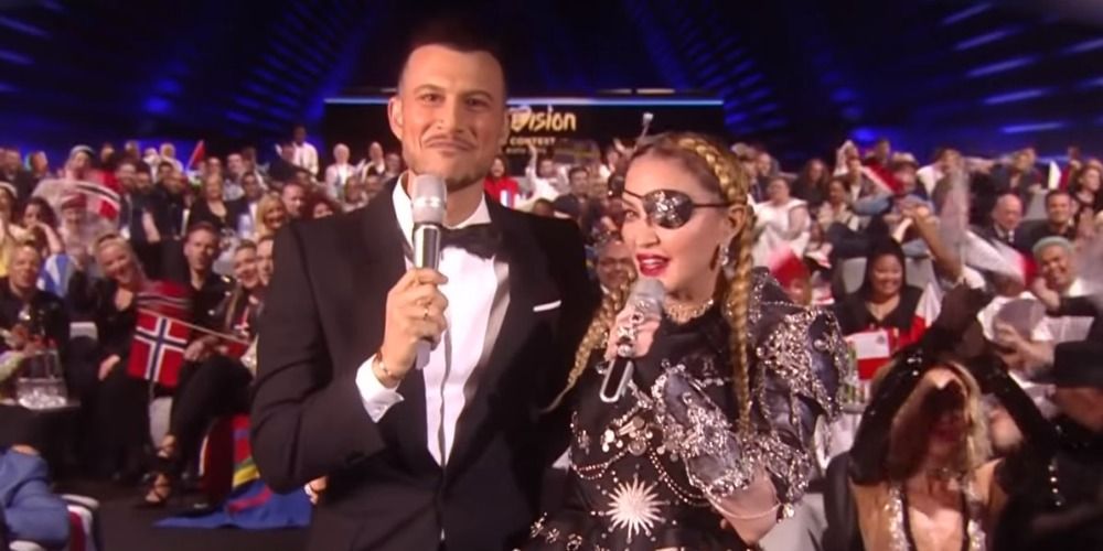 Assi Azar with Madonna at Eurovision, Madonna is wearing a silver suit and an eyepatch