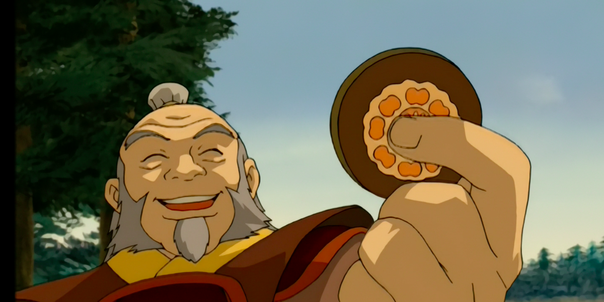 Iroh holds a white lotus Pai Sho tile