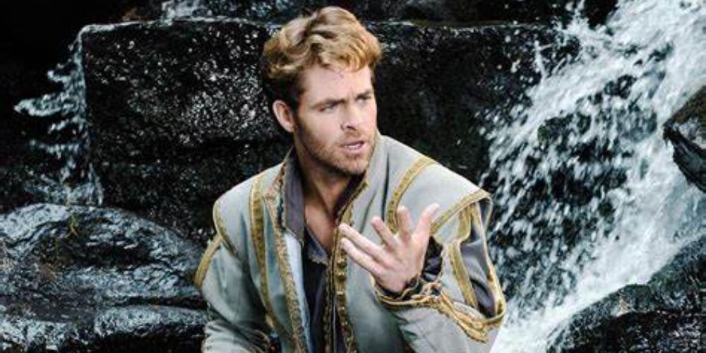 Chris Pine in Into the Woods, kneeling in a waterfall looking soulful