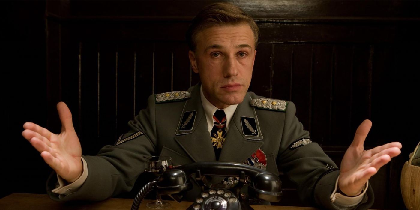 Christoph Waltz sitting in front of a phone in Inglourious Basterds