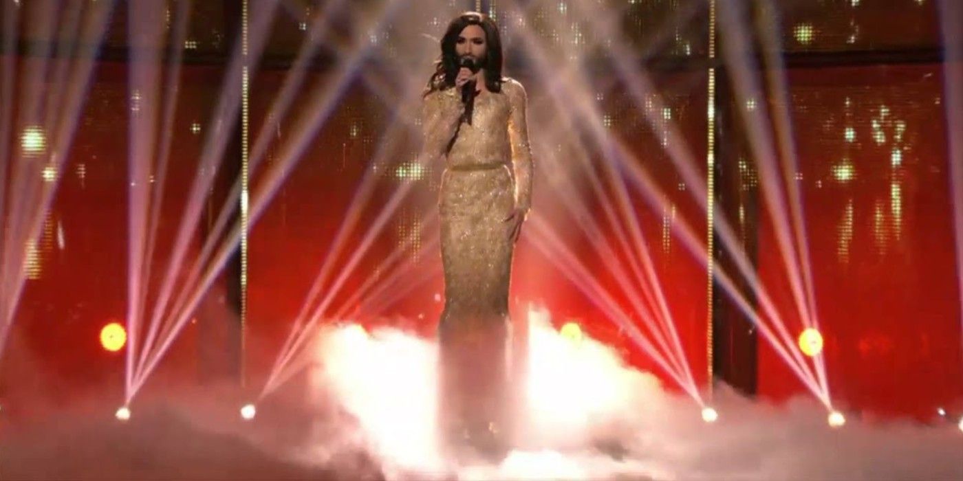Conchita Wurst sings at Eurovision surrounded by smoke and red light