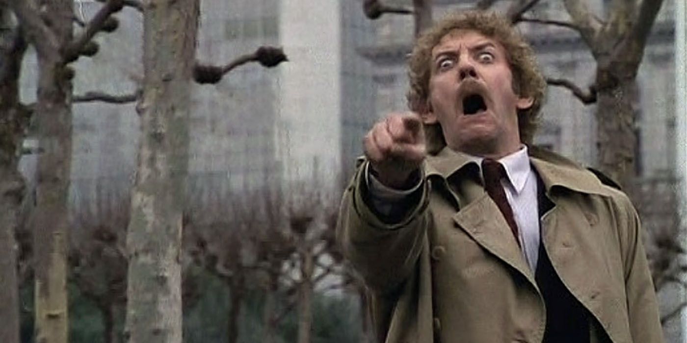 A man screaming while pointing at something in Invasion of the Body Snatchers