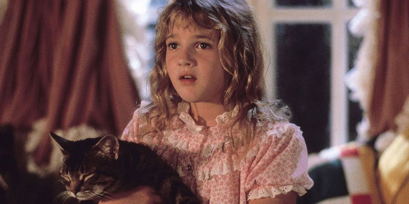 Drew Barrymore holding a cat in Cats Eye.