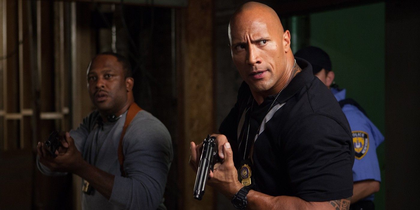 The Rock leads his police team with a gun in Empire State