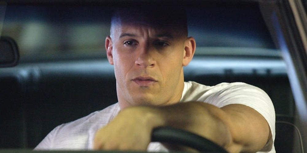 Dominic drives a car and looks sad in Tokyo Drift