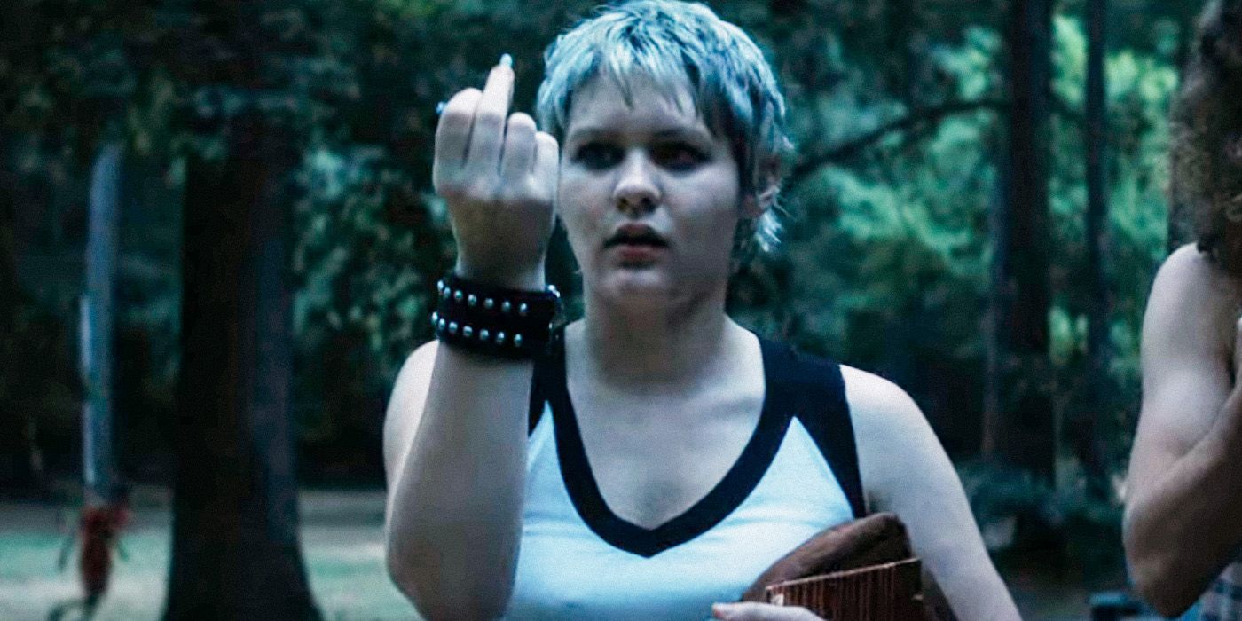 Alice lifting up her middle finger outside at Camp Nightwing in Fear Street: Part 2: 1978
