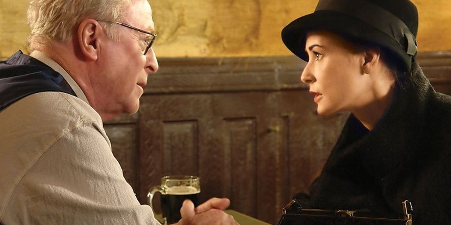 Michael Caine and Demi Moore sit at a table and talk in Flawless.
