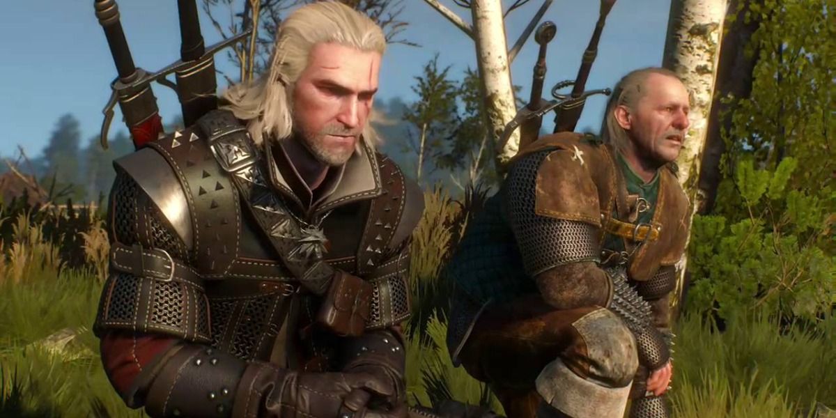 Geralt and Vesemir crouching in the grass during an early cutscene in The Witcher 3