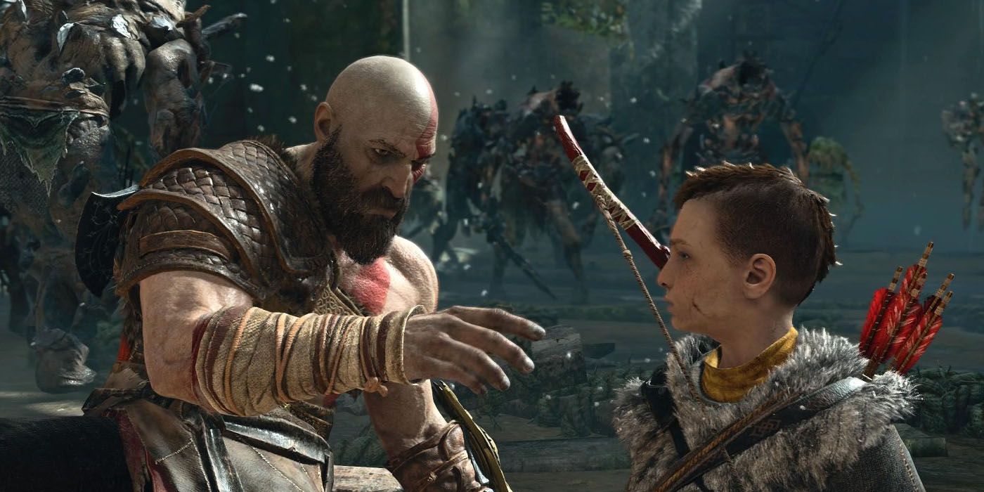 Kratos reaches out to talk to his son Atreus in 2018's God Of War video game.