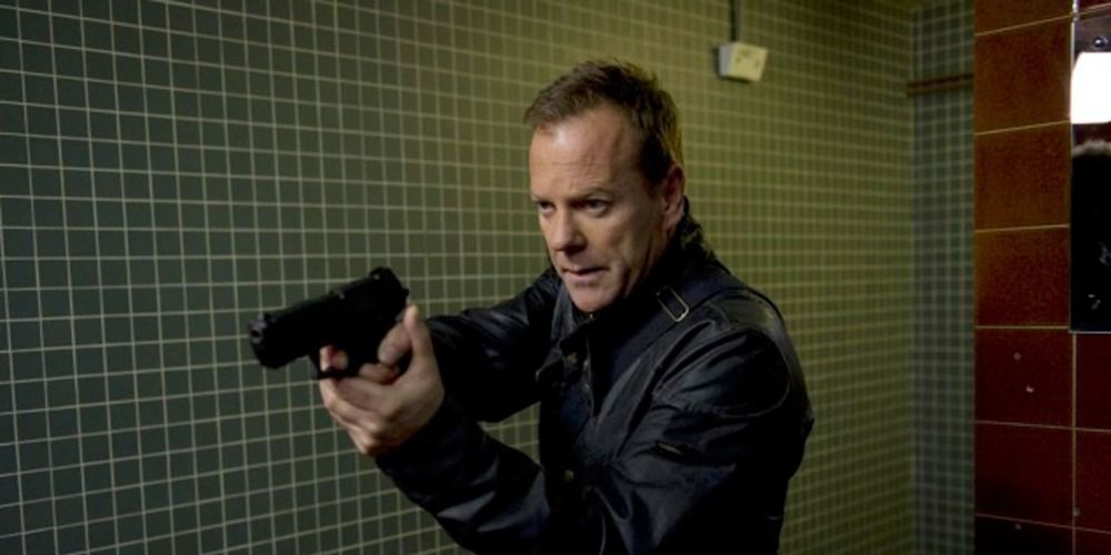 Jack Bauer from 24 holding a gun in a bathroom