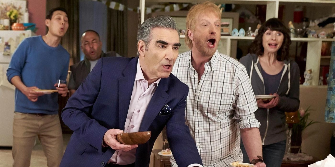 Johnny and Roland at the baby shower on Schitt's Creek