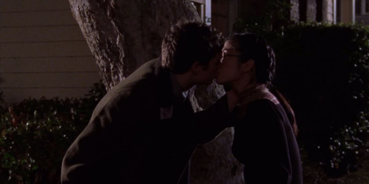 Lane and Dave Kiss outside by a tree at night in Gilmore Girls.