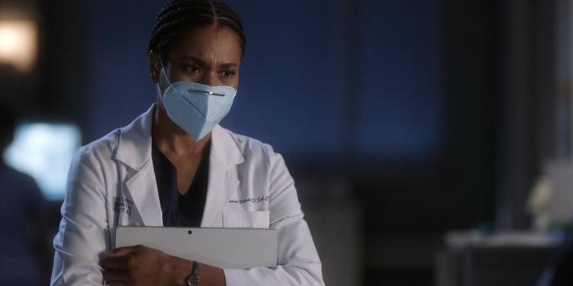 Maggie Pierce holds a crossword puzzle as she visits an ailing Meredith in Grey's Anatomy