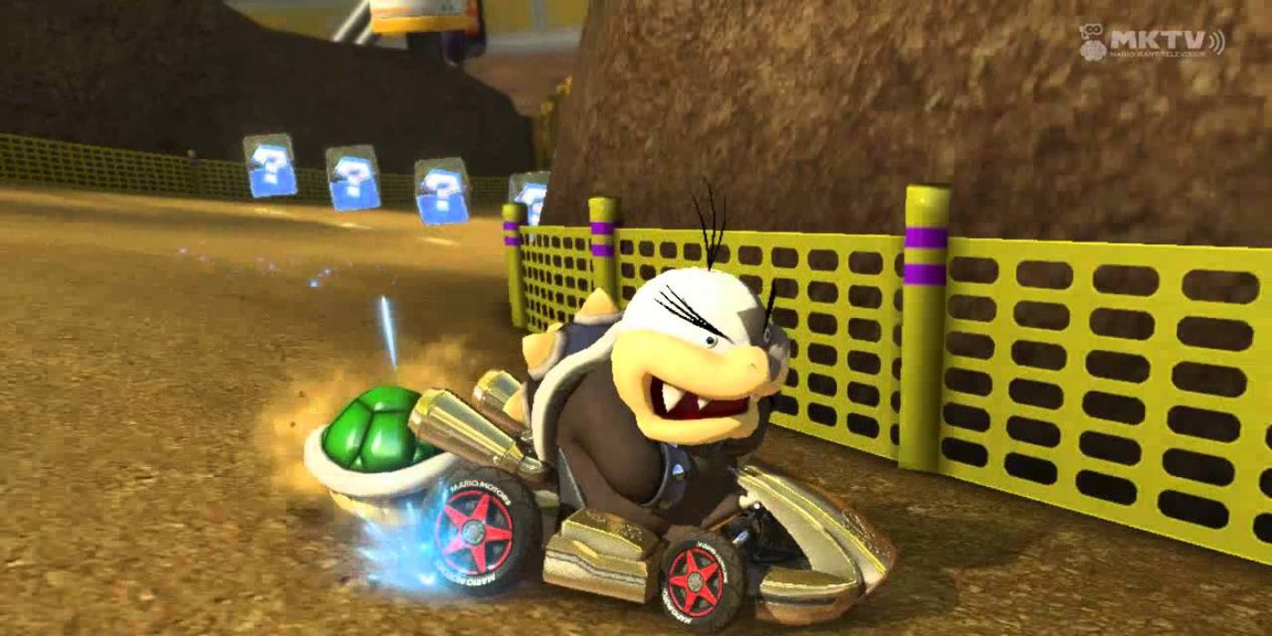 Morton is driving with a green shell on his back in Mario Kart 8.