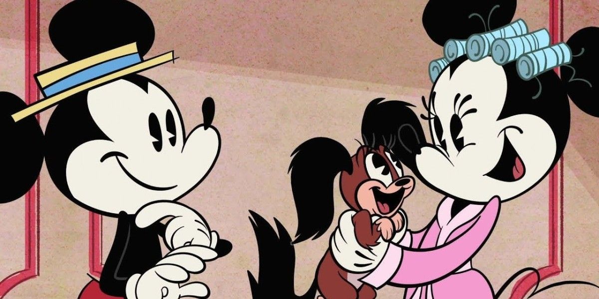 Minnie Mouse holds Fifi in a bathrobe while Mickey smiles
