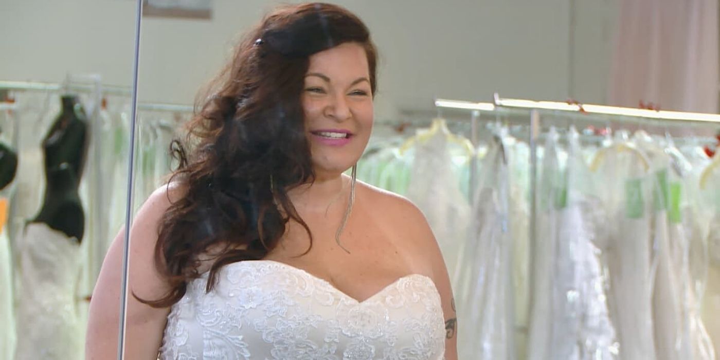 Molly Hopkins smiling while trying on a wedding dress in 90 Day Fiance