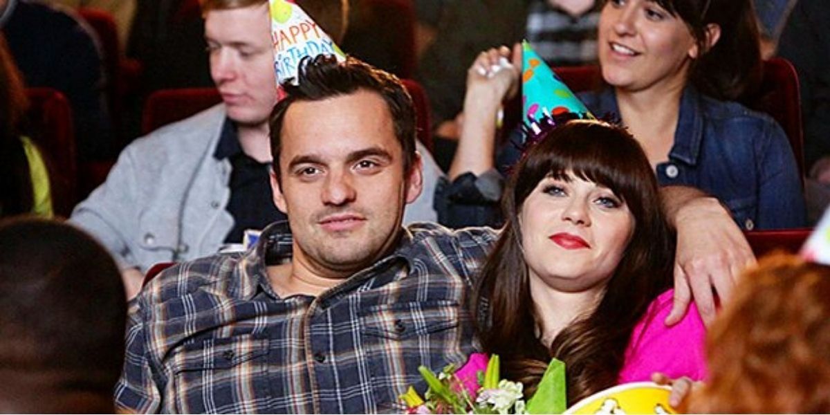 Jess and Nick wearing birthday hats at the movies on New Girl