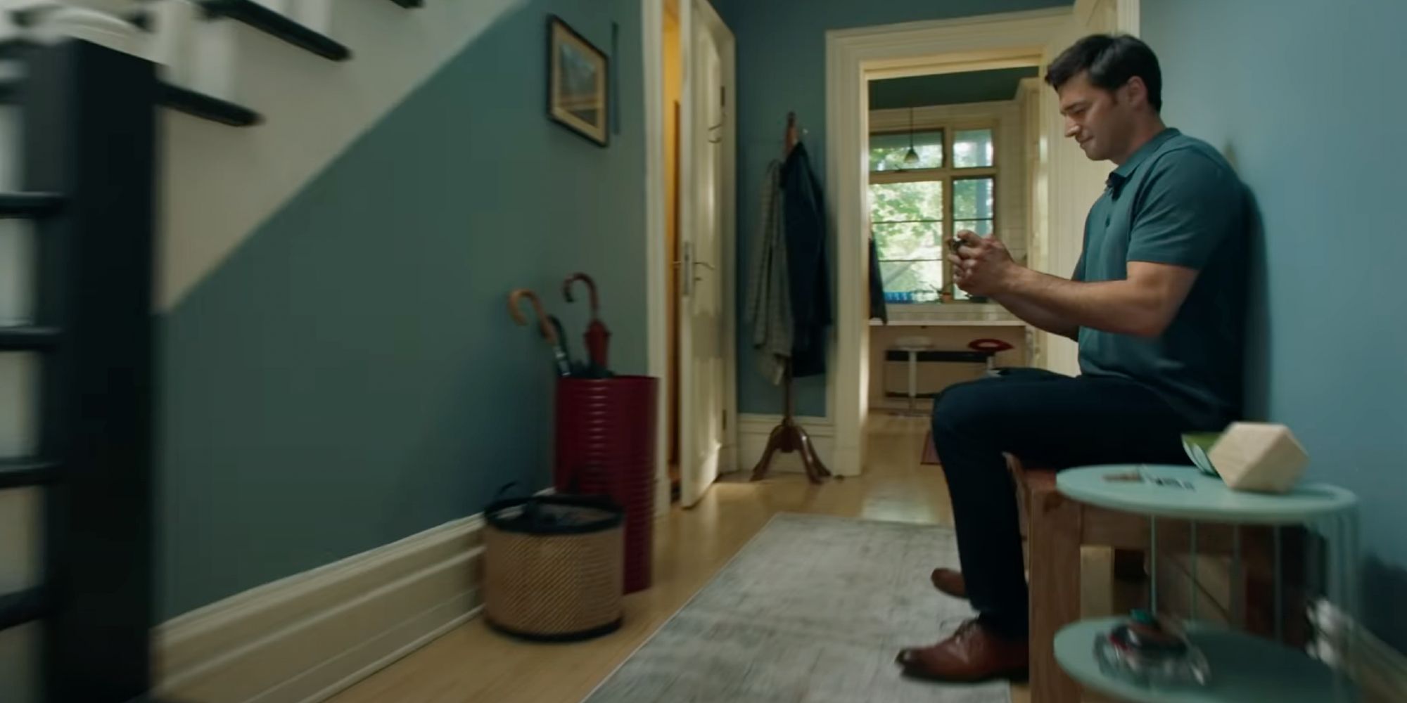 A Switch ad shows a man sitting in his entryway to play Switch