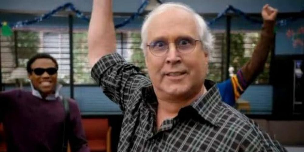 Pierce Hawthorne from Community smiling with wide eyes and his hand raised in the air, Troy and Abed smile behind him wearing sunglasses
