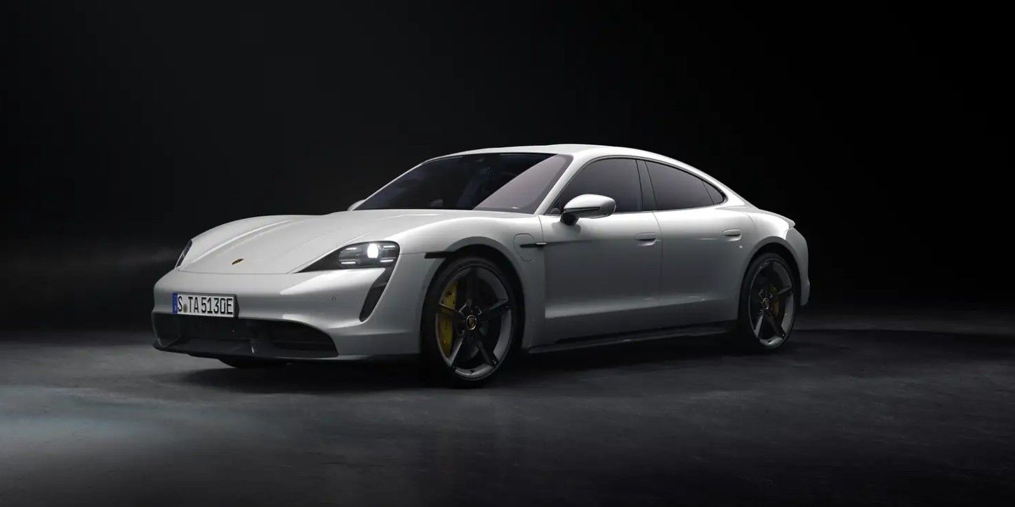 A Porsche Taycan parked against a dark background.