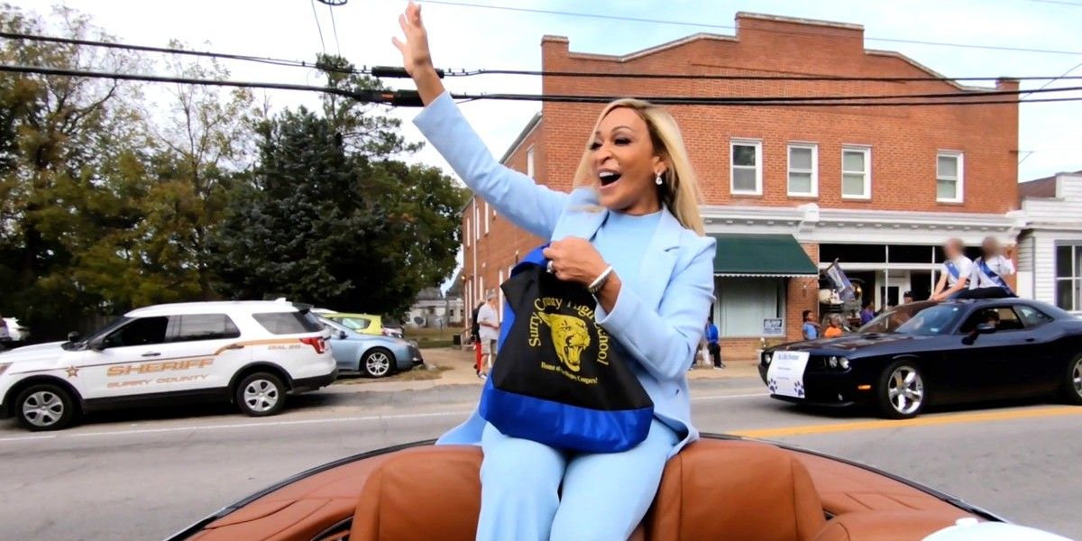 Karen Huger waving while riding in a parade on The Real Housewives of Potomac.
