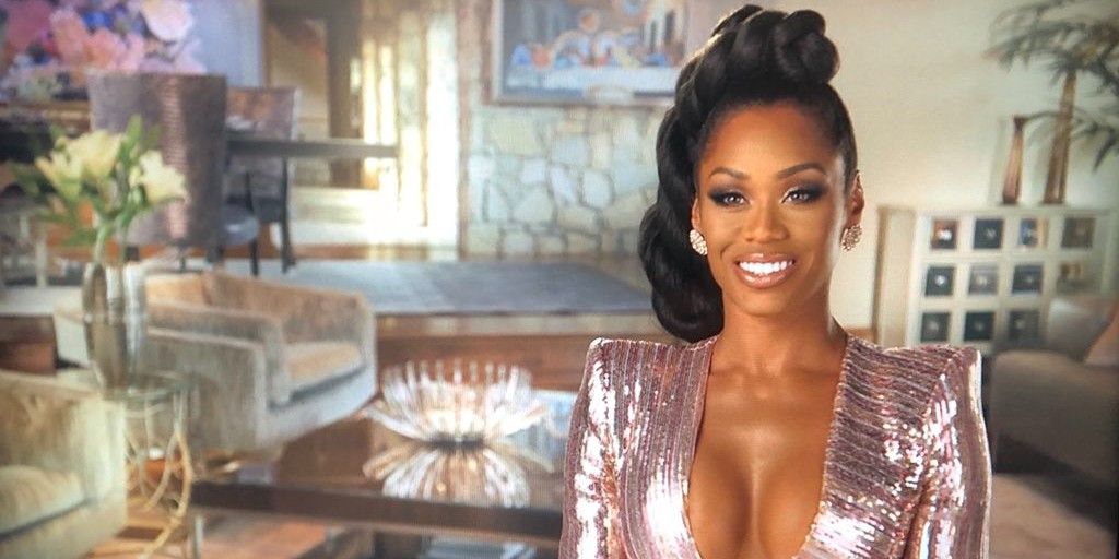 This is a photo of Monique Samuels in a sparkly, pink dress during a confessional interview on Bravo's 'The Real Housewives of Potomac.'